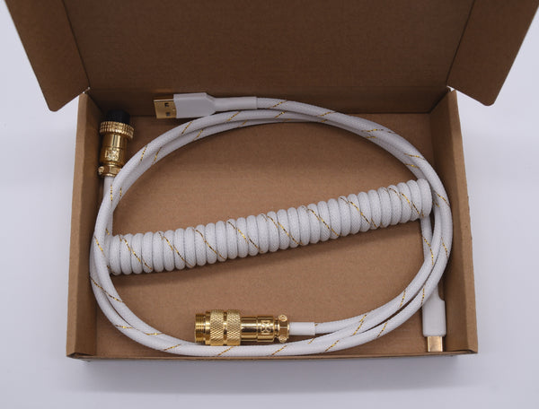 white and gold coiled usb keyboard cable